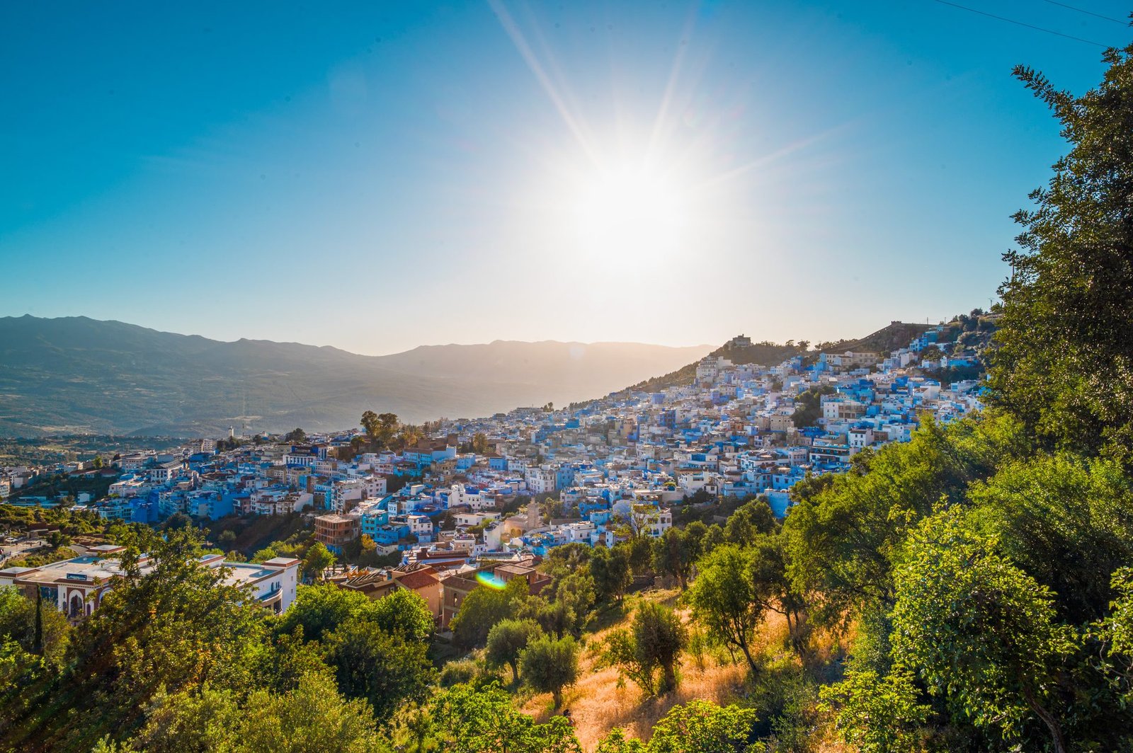 Chefchaouen's blue medina at sunrise beneath the Rif Mountains